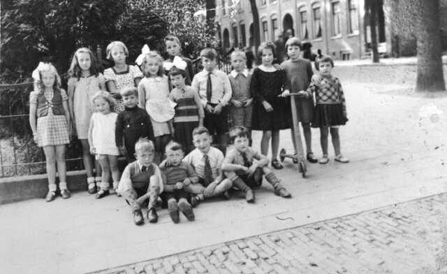 Julius Reindert Looper  (at the front, 2nd on the left) with children in the neighbourhood , around 1939