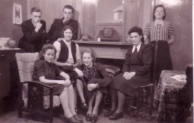 Clara de Boers, sitting on the chair, on the right with friends
