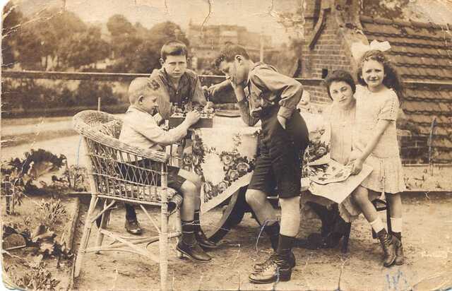 Rudolf (standing in front of the table) with younger brother Günter (standing behind table) and cousin Hermann and (sitting left) and cousin Selma (standing right) and mother Rosalie Heidemann Lewisohn, Berlin 1925 or 1926.